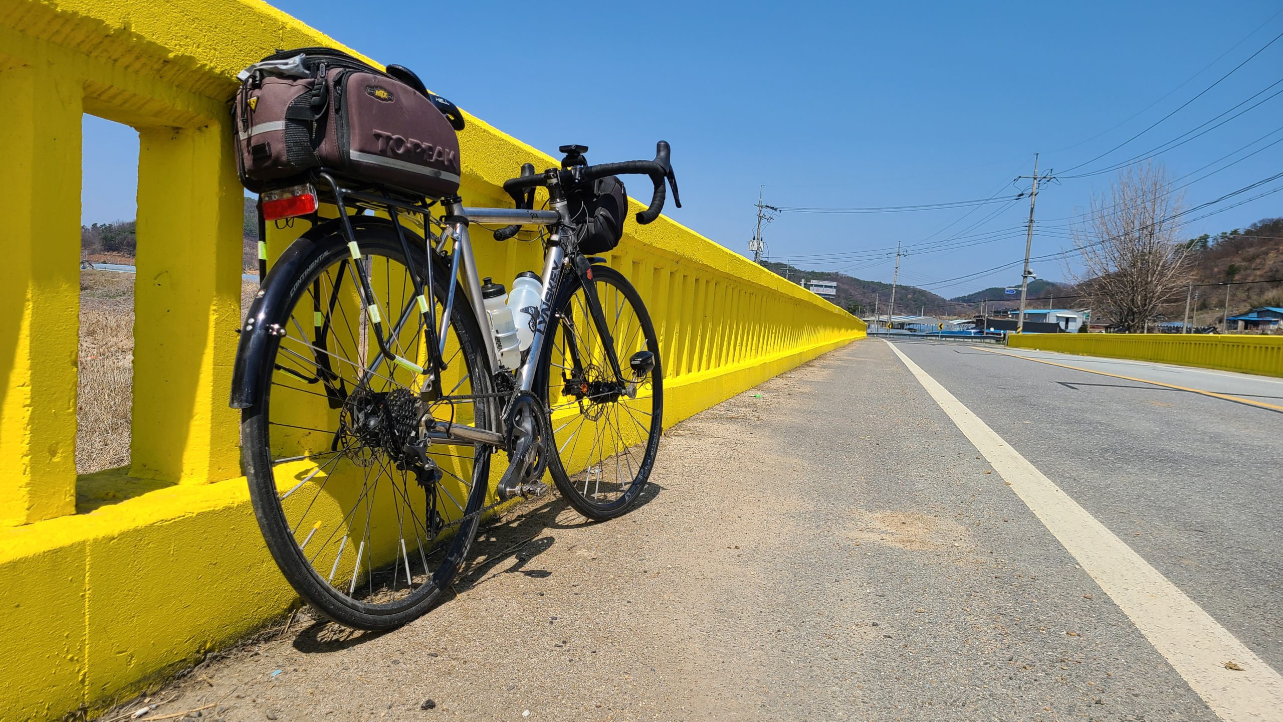 bicycle against yellow bridge