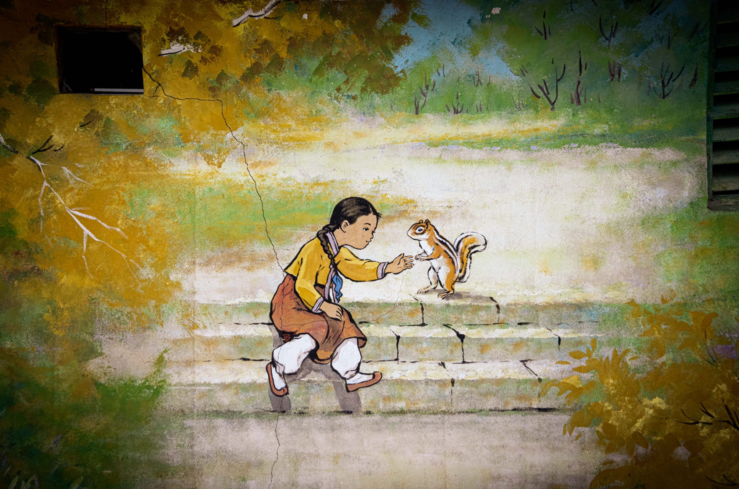 wall mural of a Korean girl wearing a hanbok playing with a squirrel